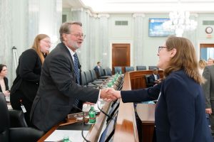 Dr. Laura Sandt shakes hands with U.S. Senator Gary Peters.