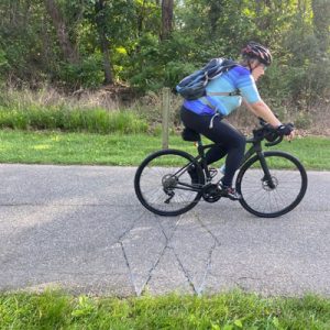 Person riding a bike on a paved greenway.