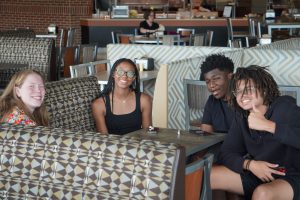 Mentor sits with students of the Summer Transportation Institute.