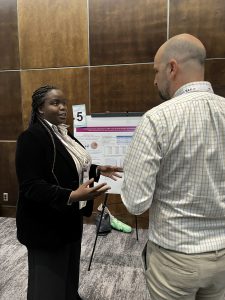 A student discusses her poster with an attendee at the Safe Mobility Conference.