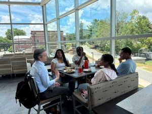 Mentor sits with students of the Summer Transportation Institute.